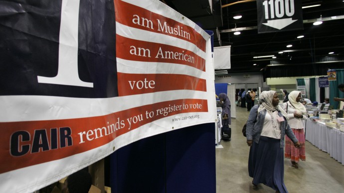 A sign in the bazaar at the 43rd annual ISNA convention encourages participants to register to vote  Friday, Sept, 1, 2006 in Rosemont, Ill. (AP Photo/M. Spencer Green)