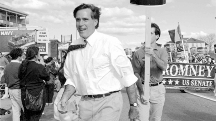 In this Oct. 10, 1994, file photo, Republican U.S. senatorial candidate Mitt Romney greets supporters at the Columbus Day parade in Worcester, Mass., following his father's path into politics. (AP Photo/C.J. Gunther, File)
