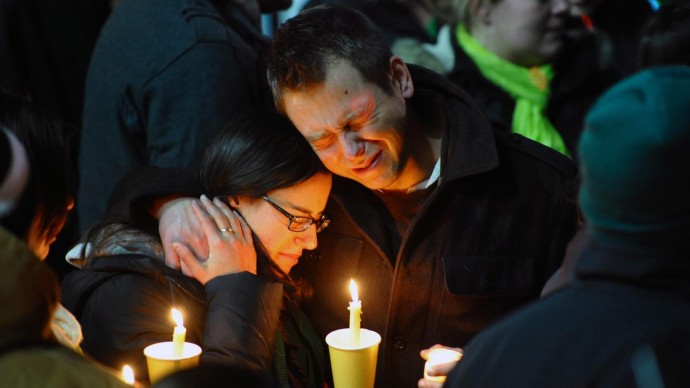Ted Kowalczuk, of Milford, Conn., and his friend Rachel Schiavone, of Norwalk, Conn., attend a candlelight vigil held behind Stratford High School on the Town Hall Green in Stratford, Conn. on Saturday December 15, 2012. Kowalczuk and Schiavone were close friends to Stratford High graduate Vicki Soto, who was killed in yesterday's mass shooting at Sandy Hook Elementary School in Newtown. Soto was a teacher at the school.(AP Photo/The Connecticut Post, Christian Abraham)
