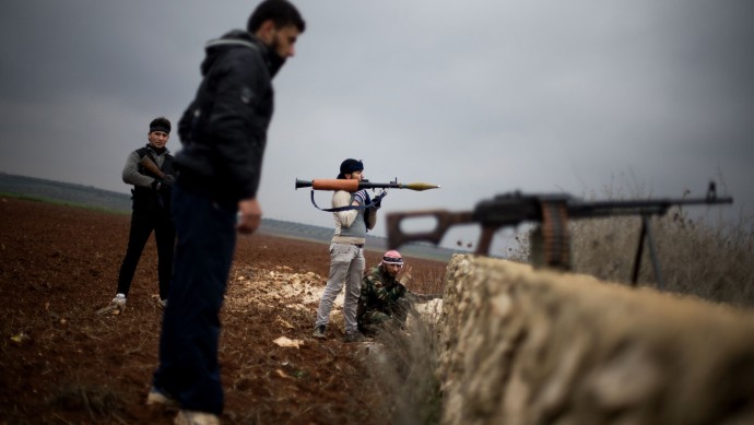 Free Syrian Army fighters take their positions, close to a military base, near Azaz, Syria, Monday, Dec. 10, 2012. (AP Photo/Manu Brabo)