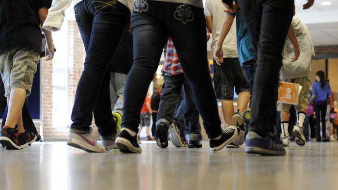 In this Sept. 11, 2012 file photo, students walk in the hallways as they enter the lunch line of the cafeteria at Draper Middle School in Rotterdam, N.Y. (AP Photo/Hans Pennink, File)
