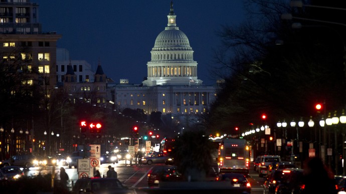Red lights illuminate Pennsylvania Avenue as the U.S. Capitol glows in the twilight, in Washington, Wednesday, Dec. 19, 2012, as talks continue on the looming fiscal cliff. (AP Photo/Jacquelyn Martin)