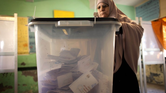 A veiled Egyptian woman casts her vote at a polling station during the second round of a referendum on a disputed constitution drafted by Islamist supporters of president Mohammed Morsi, in Giza, Egypt, Saturday, Dec. 22, 2012. (AP Photo/Nasser Nasser)