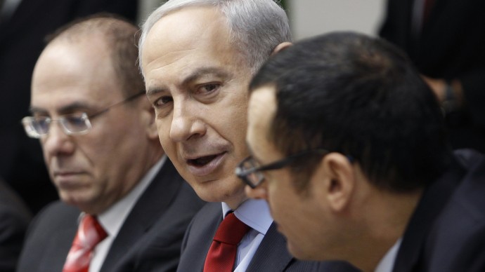 Israeli Prime Minister Benjamin Netanyahu, center, attends the weekly cabinet meeting in his Jerusalem office, Sunday, Dec. 9, 2012. (AP Photo/Ammar Awad, Pool)