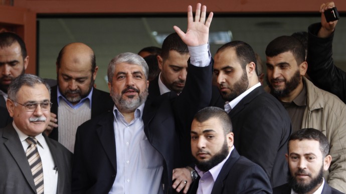Hamas leader Khaled Mashaal waves during his visit to the Islamic University in Gaza city, Sunday, Dec. 9, 2012. (AP Photo/Hatem Moussa)