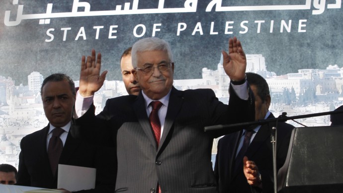 Palestinian President Mahmoud Abbas, waves to the crowd during celebrations for their successful bid to win U.N. statehood recognition in the West Bank city of Ramallah, Sunday, Dec. 2, 2012. (AP Photo/Nasser Shiyoukhi)
