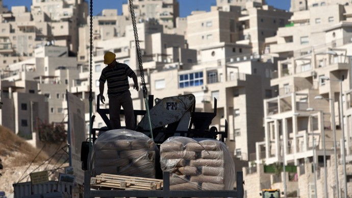 In this Nov. 2, 2011 file photo, a construction worker works on a new housing unit in the east Jerusalem neighborhood of Har Homa. (AP Photo/Sebastian Scheiner, File)
