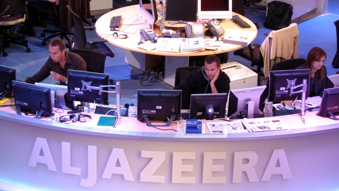 Al Jazeera English Channel staff prepare for the broadcast in Doha news room in Qatar on Tuesday, Nov. 14, 2006. (AP Photo/ Hamid Jalaudin)