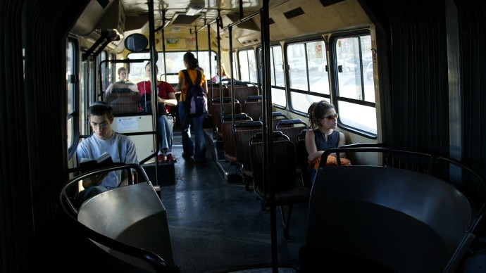 Students ride in an nearly empty bus on their way to school. (AP photo/Oded Balilty)