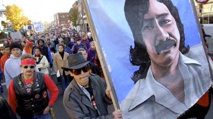 Marchers carry a large painting of American Indian Leonard Peltier during a "National Day of Mourning," Thursday, Nov. 22, 2001, in Plymouth, Mass. (AP Photo/Steven Senne)