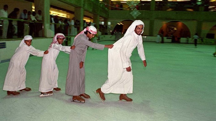 Four UAE nationals wearing traditional clothing enjoy and an afternoon of ice skating at the rink inside the Hyatt Regency in January 1989. (Photo Norbert Schiller)