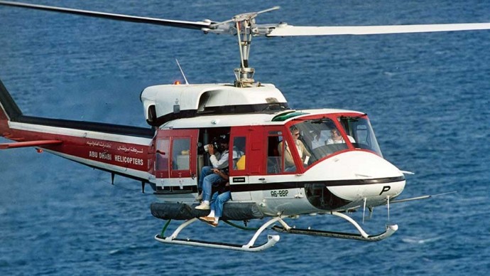 A cameraman for one of the television networks leaning out of a news helicopter. (Photo Norbert Schiller)