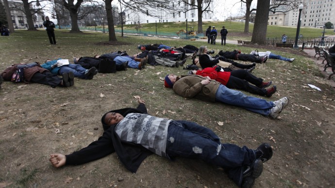 In a Monday, Jan. 17, 2011 file photo, gun violence protesters participate in a lie-in during an anti-gun rally at the Capitol in Richmond, Va. (AP Photo/Steve Helber, File)