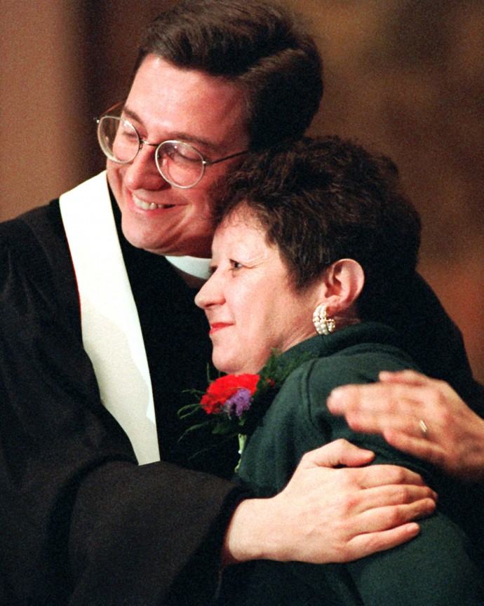 In this Sunday, Jan. 21, 1996 file photo, Norma McCorvey, Jane Roe in the 1973 Roe v. Wade decision, is embraced by The Rev. Robert L. Schenck of the National Clergy Council before she addresses a memorial service at Georgetown University in Washington. (AP Photo/Cameron Craig)
