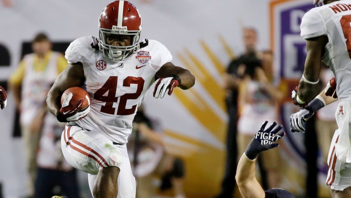 Alabama's Eddie Lacy (42) runs past Notre Dame's Danny Spond (13) during the first half of the BCS National Championship college football game Monday, Jan. 7, 2013, in Miami. (AP Photo/David J. Phillip)