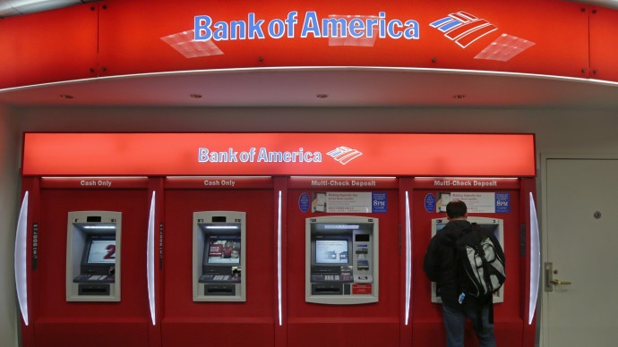 In this Dec. 13, 2012 photo, a customer stops at a Bank of America ATM office in Boston. (AP Photo/Charles Krupa)