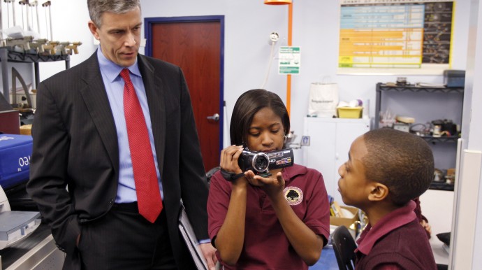 In this Friday, April 15, 2011 photo, U.S. Department of Education Secretary Arne Duncan is questioned by student Trebor Goodall, right, as he's videotaped by fellow student Faith Brown during a tour of the Charles A. Tindley Accelerated School in Indianapolis. (AP Photo/Michael Conroy)