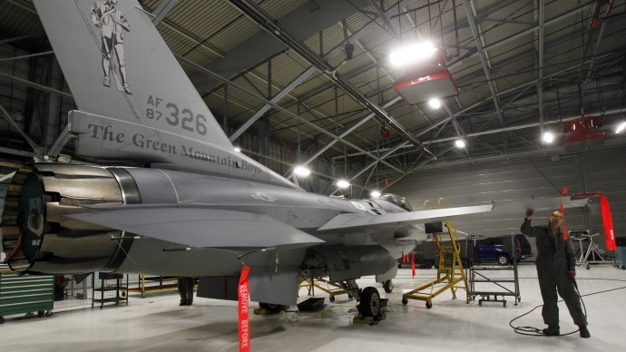 In this Monday, Dec. 17, 2012 photo, Master Sgt. Andrew Ehlers does repairs on an F-16 fighter plane in South Burlington, Vt. (AP Photo/Toby Talbot)