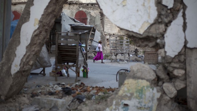 A woman walks past buildings damaged by the 2010 earthquake in downtown Port-au-Prince, Haiti,  Wednesday, Jan. 9, 2013. (AP Photo/Dieu Nalio Chery)
