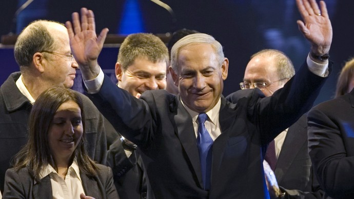 Israeli Prime Minister Benjamin Netanyahu, center, waves during the inauguration of his election campaign in Jerusalem, Tuesday, Dec. 25, 2012. (AP Photo/Dan Balilty)