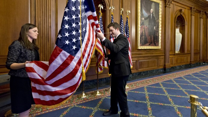 Anne Easby-Smith, left, and Trace Robbins, right, who work for House Speaker John Boehner, help to prepare the Rayburn Room on Capitol Hill in Washington,Wednesday, Jan. 2, 2013, where members of the House of Representatives will pose for pictures at an oath of office ceremony with Boehner. (AP Photo/J. Scott Applewhite)