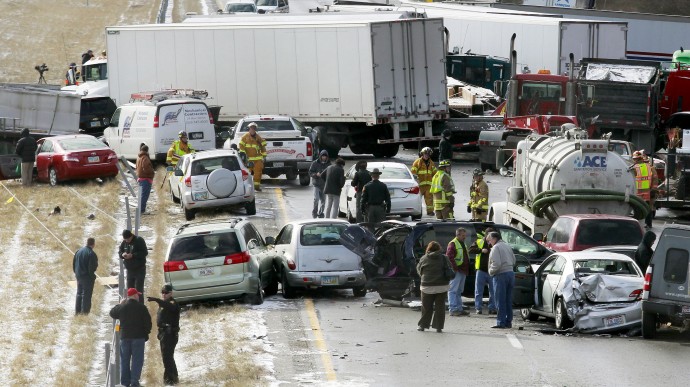 Semi-trucks and other vehicles involved in a mulit-car crash are strewn across westbound Interstate 275 between Colerain Avenue and Hamilton Avenue Monday, Jan. 21, 2013 in Cincinnati. (AP Photo/Cincinatti Enquirer, Cara Owsley)