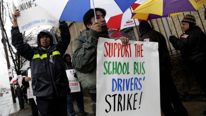 Bus drivers and supporters walk a picket line in front of a bus depot in New York, Wednesday, Jan. 16, 2013. (AP Photo/Seth Wenig)