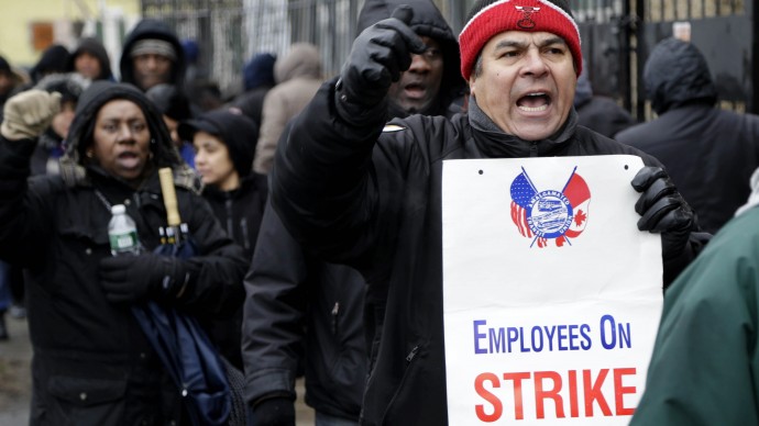 Bus drivers and supporters walk a picket line in front of a bus depot in New York, Wednesday, Jan. 16, 2013. (AP Photo/Seth Wenig)