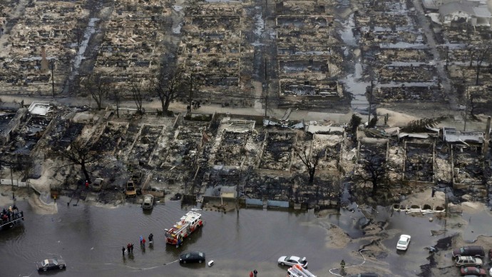 An Oct. 30, 2012, file photo shows an aerial view of burned-out homes in the Breezy Point section of the Queens borough New York after a fire in the beachfront neighborhood as a result of superstorm Sandy. (AP Photo/Mike Groll, File)