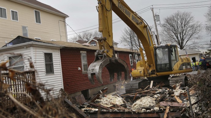 A home that was severely damaged by Superstorm Sandy is demolished in the Staten Island borough of New York, Monday, Jan. 14, 2013. (AP Photo/Seth Wenig)