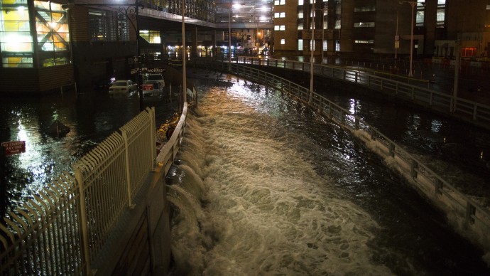 In this Oct. 29, 2012 file photo, sea water floods the entrance to the Brooklyn Battery Tunnel in New York during Superstorm Sandy. (AP Photo/ John Minchillo, File)