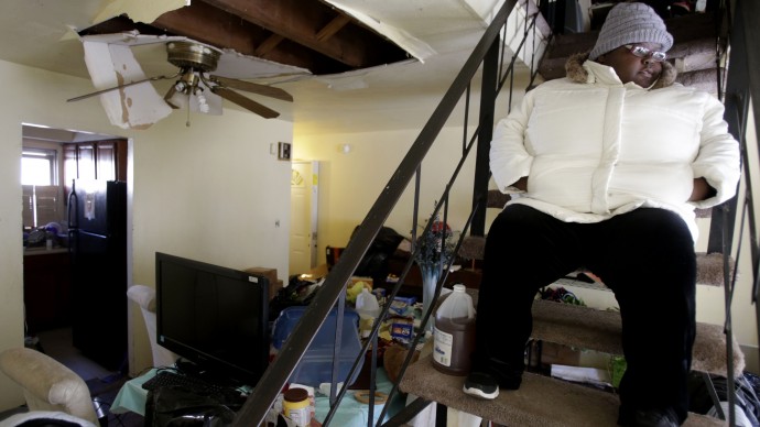 Ayanna Diego looks over her living room while waiting for inspectors at her home, which was damaged by Superstorm Sandy, in the Rockaways section of New York, Thursday, Jan. 24, 2013. (AP Photo/Seth Wenig)