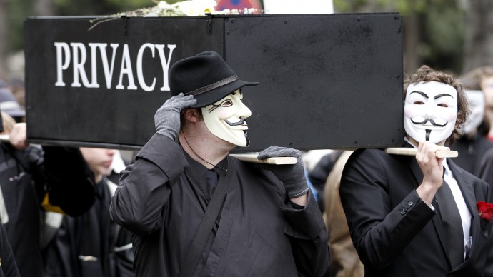 Protesters with Guy Fawkes masks demonstrate on March 31, 2012 in Vienna, Austria with a replica of a coffin marked "Privacy" against data retention. (Photo Ronald Zak/file)